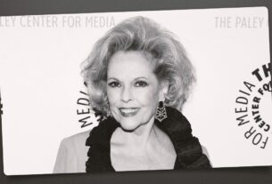 Eileen Fulton smiling on a carpet