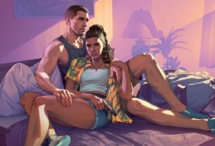 A man and woman sit in a bed.