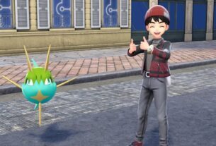 Shep standing next to a shiny Carvahna.